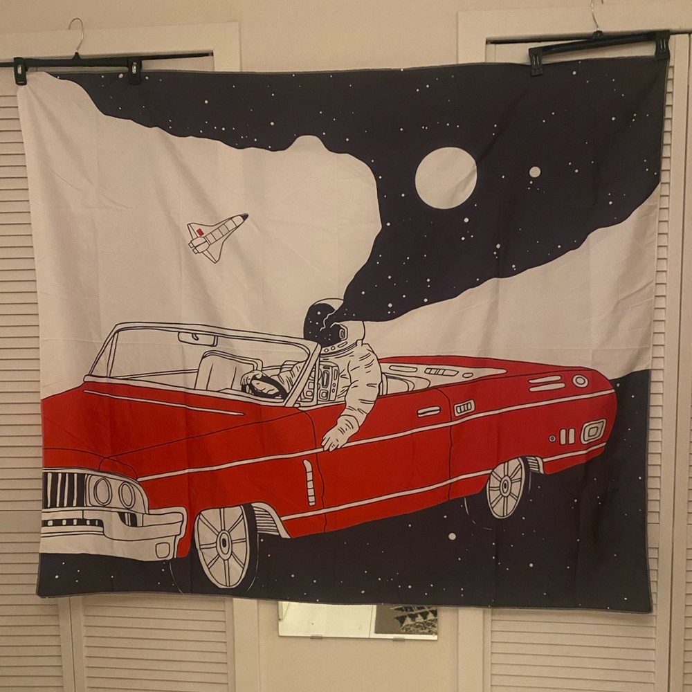 Astronaut in Red Convertible Tapestry